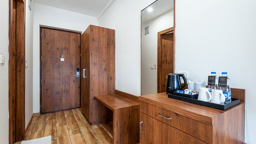 premium room with tea & coffee maker and a wooden wardrobe at DLS The Classio